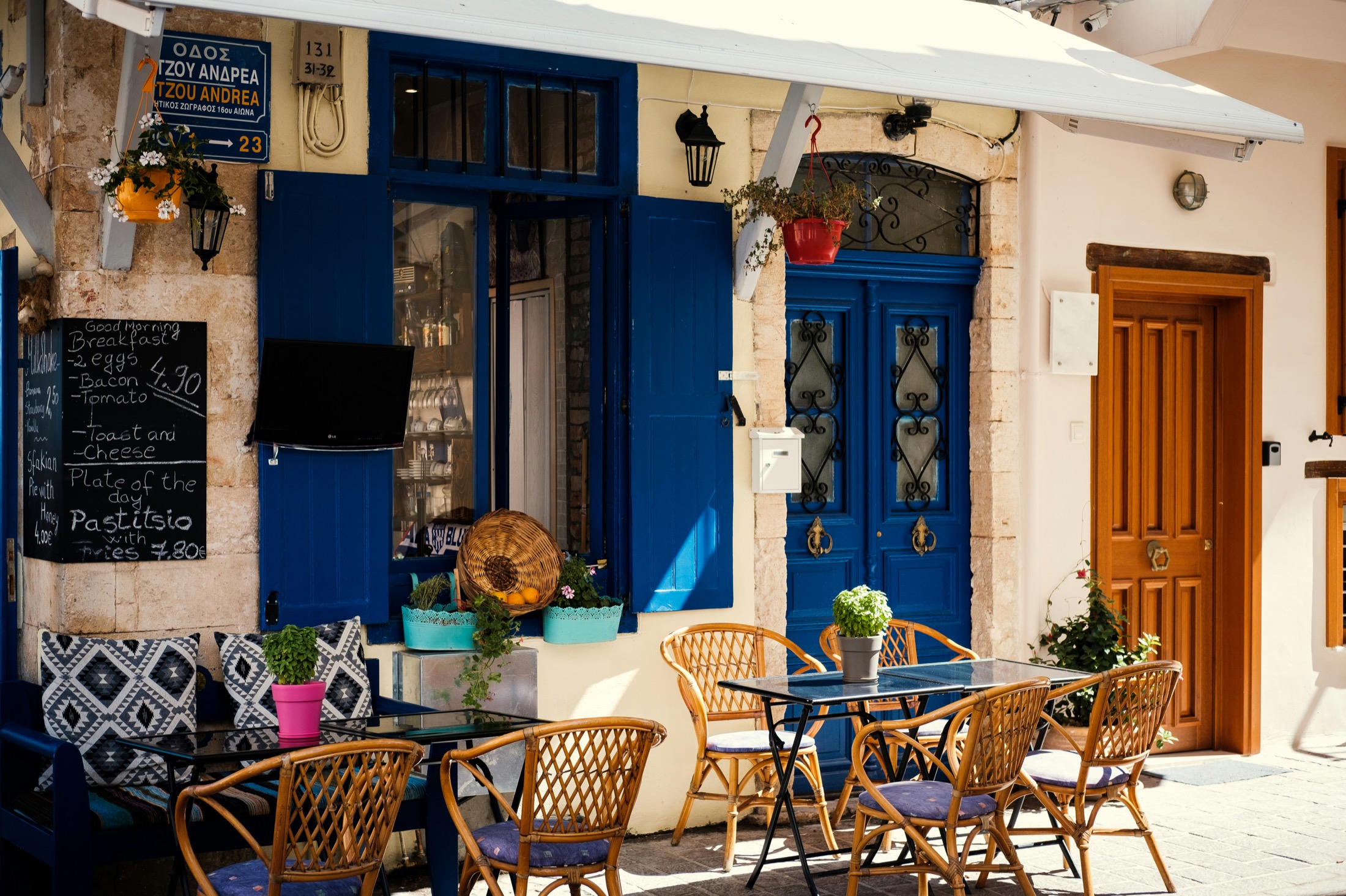 A quiet Cretan street café with blue doors